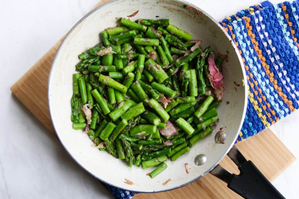 chopped asparagus and bacon in skillet