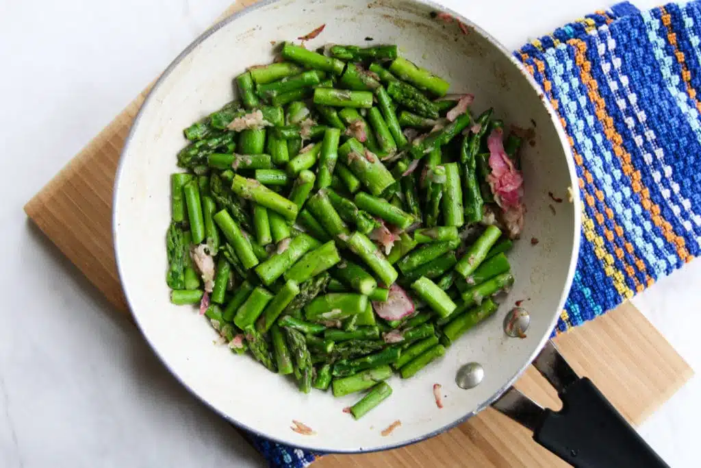 chopped asparagus and bacon in skillet