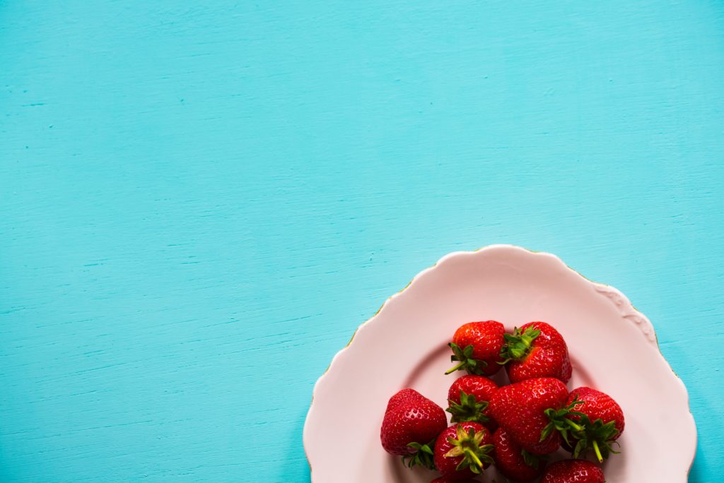 strawberries-white-plate-blue-background