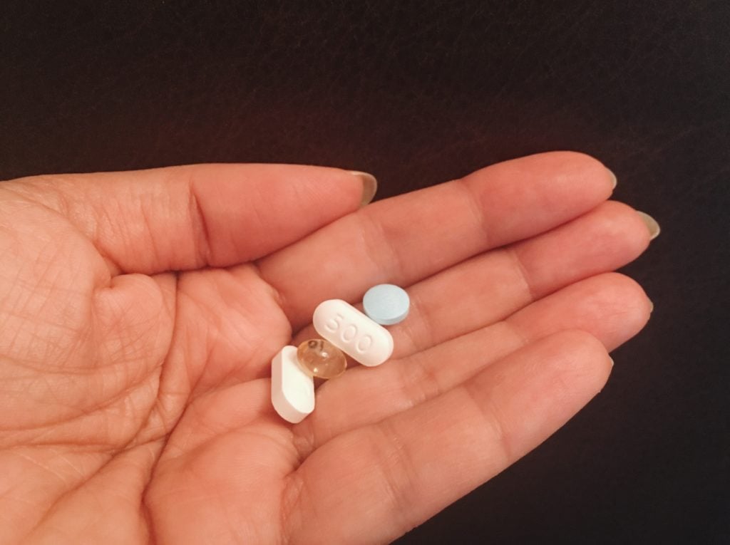 pills in woman's hand