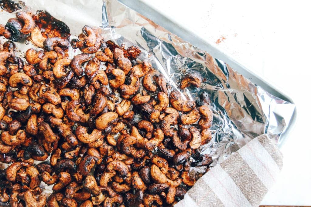 chili roasted cashews on baking sheet