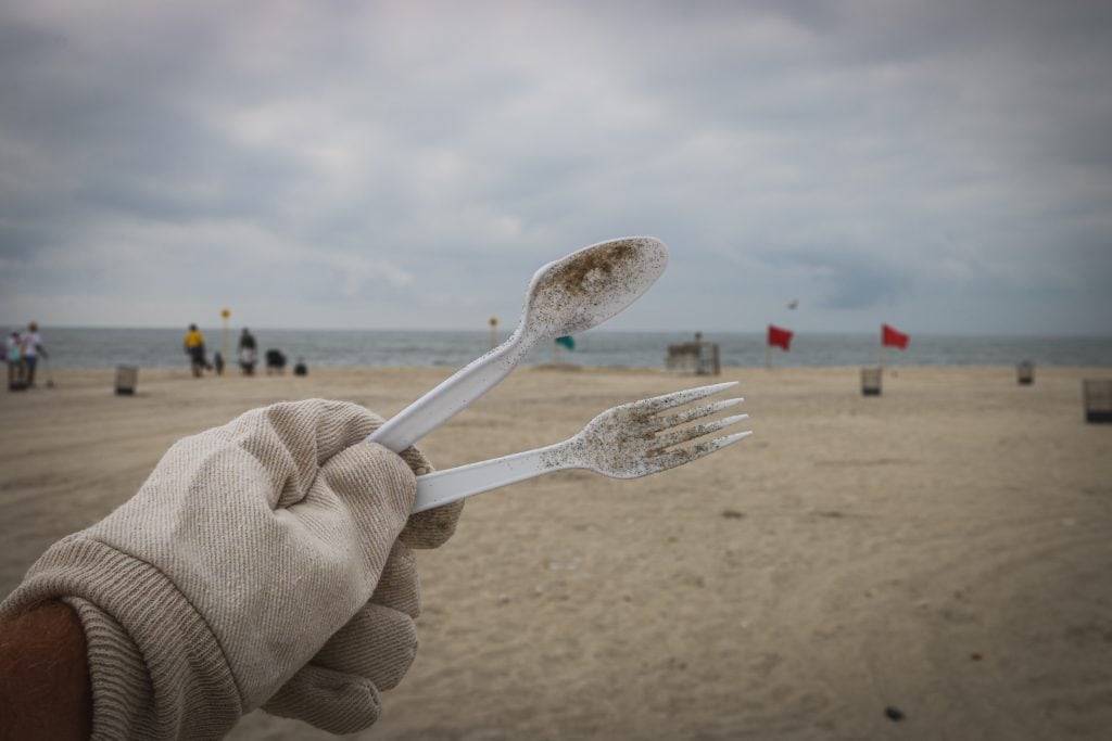 plastic fork and spoon on beach