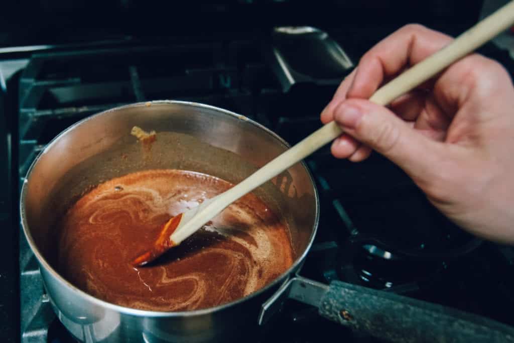 chocolate coconut fudge ingredients in saucepan on stove