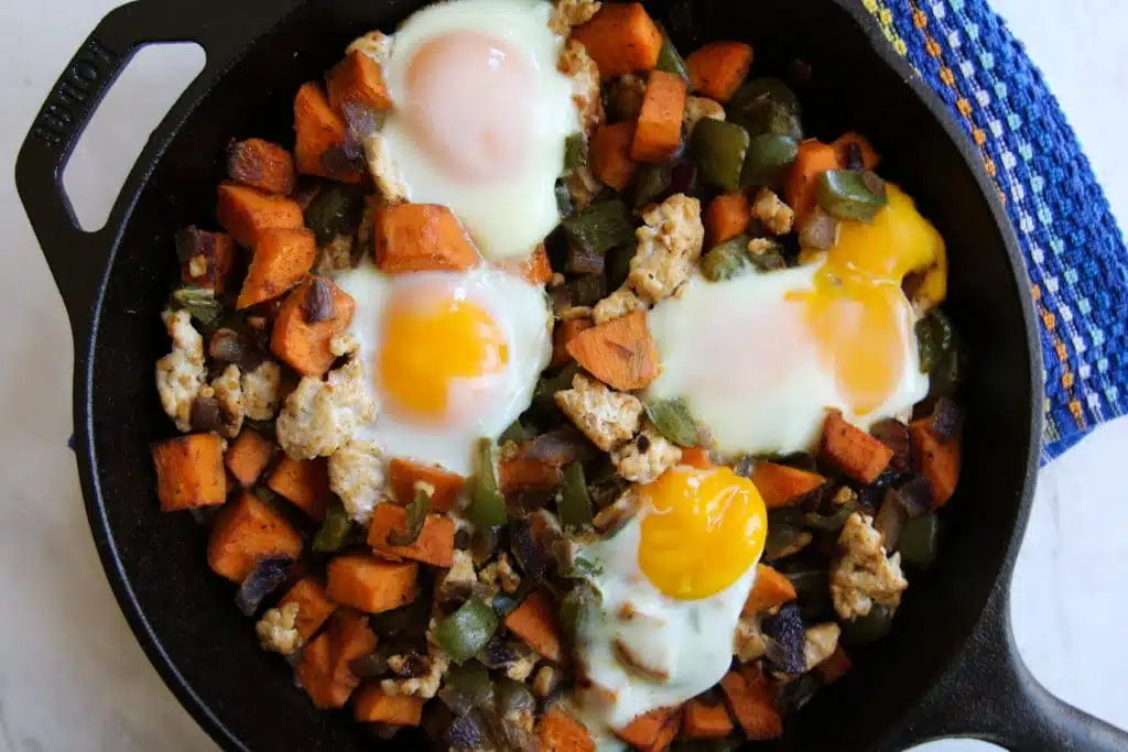 sweet potato turkey vegetable egg hash in skillet