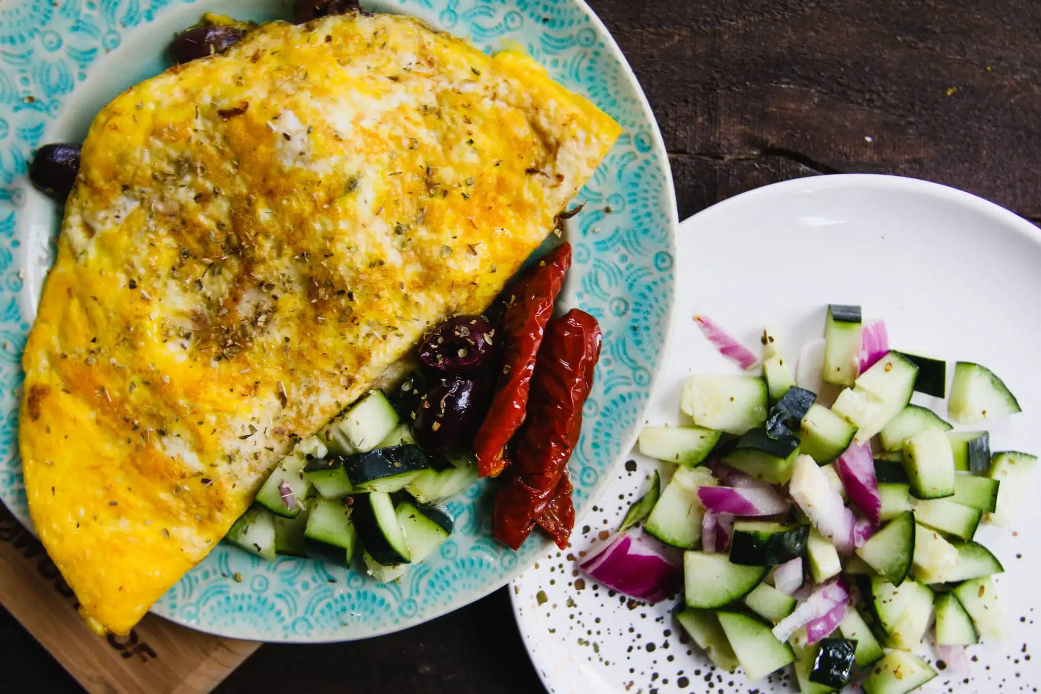 greek omelet on plate with olives and tomatoes