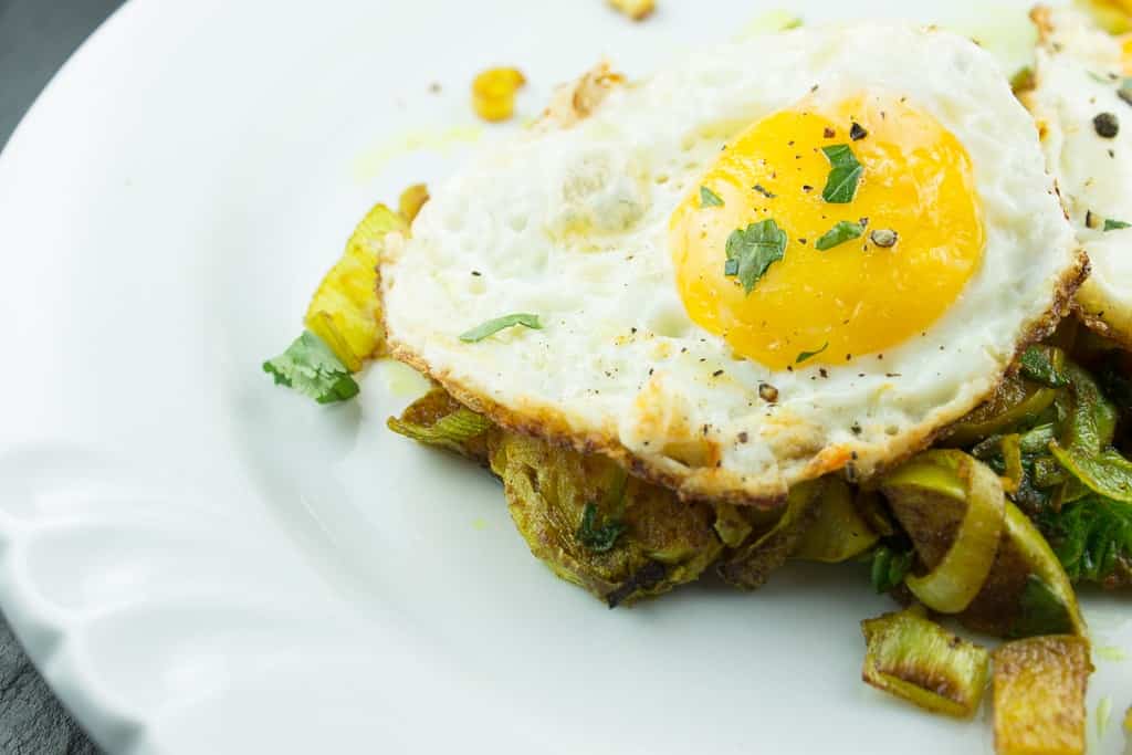 curried vegetable skillet with fried eggs