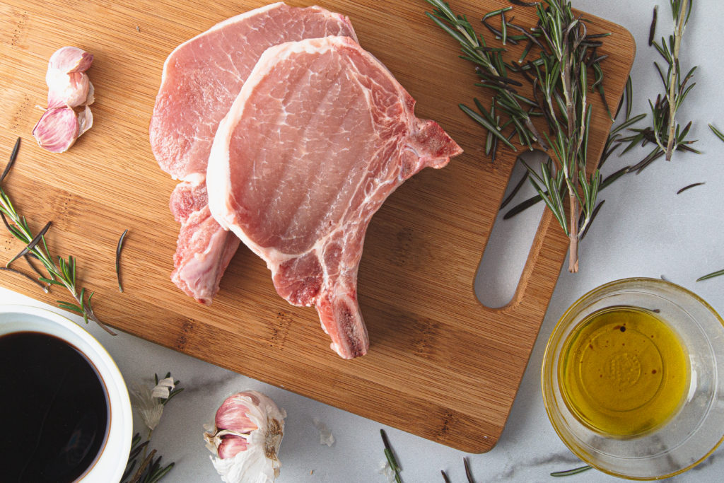 raw pork chop on cutting board