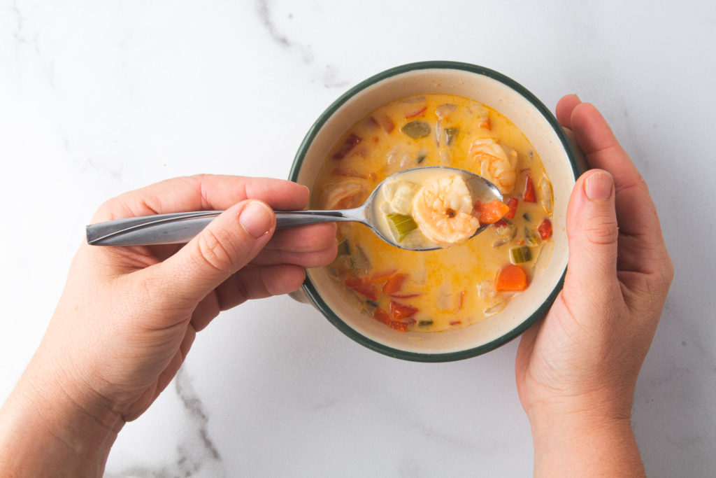 person holding bowl of chowder