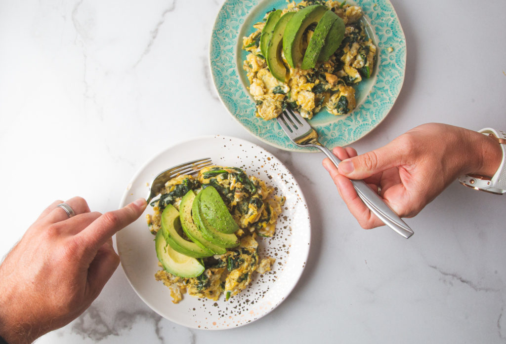 spinach and avocado scramble on plates