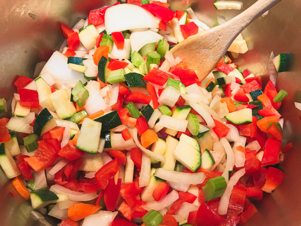 diced veggies in pot with wooden spoon