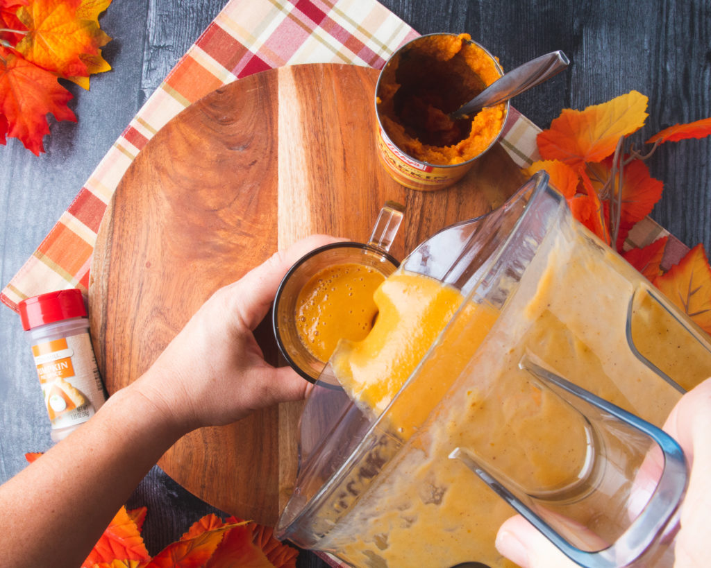 pouring pumpkin smoothie out of blender